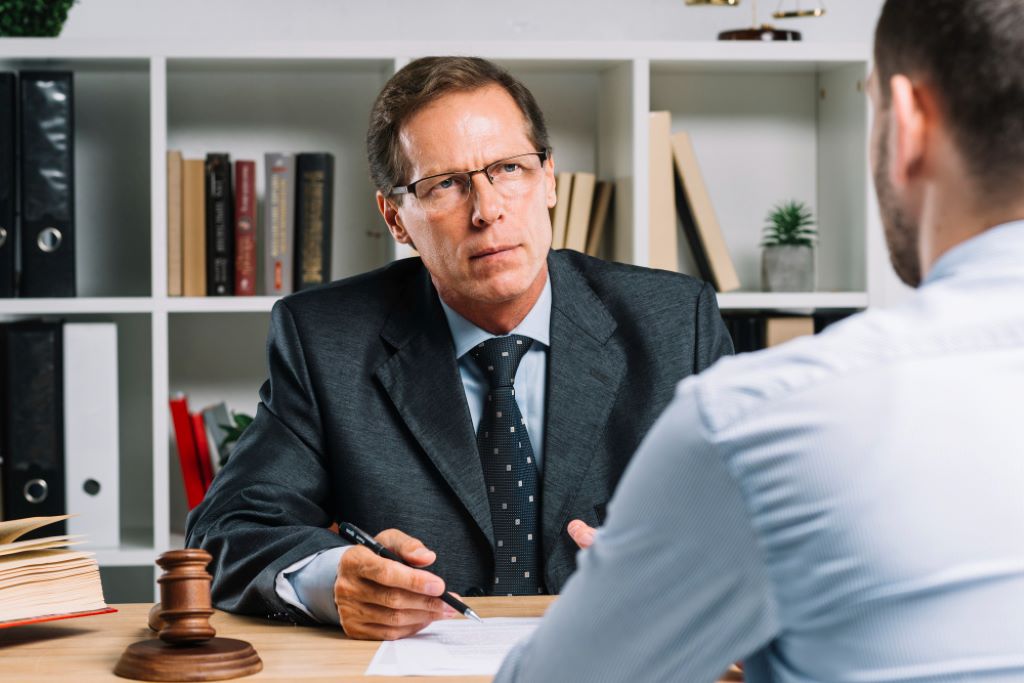 mature lawyer with clients meeting