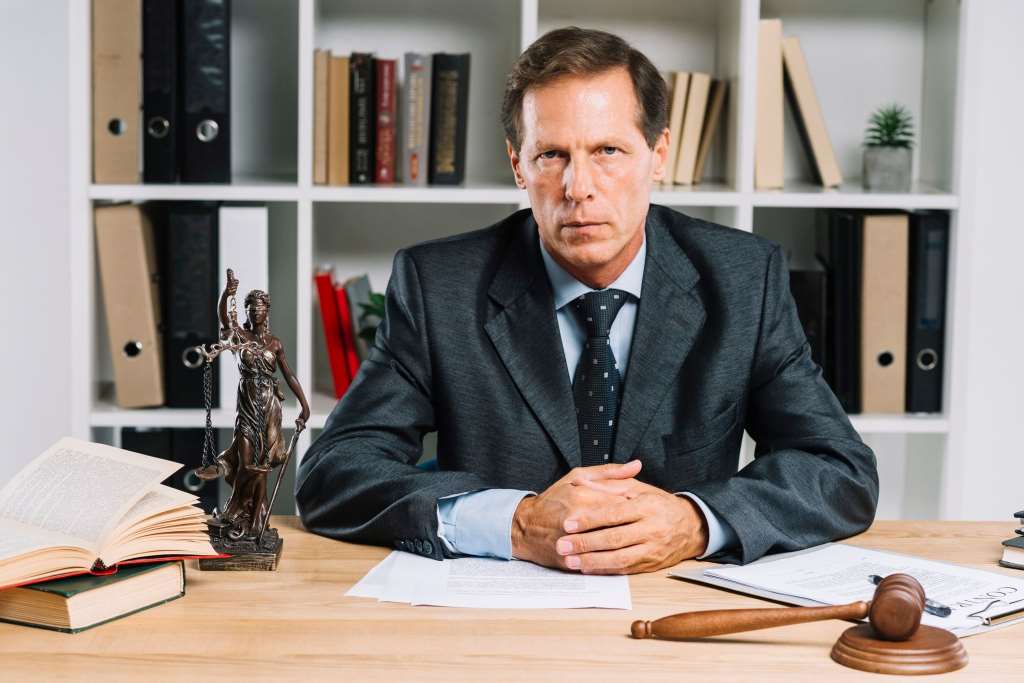 confident mature lawyer sitting in courtroom